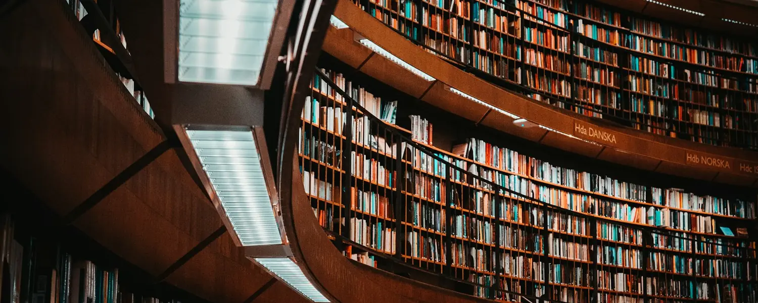 Изогнутые стеллажи с книгами в библиотеке